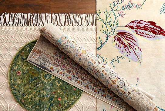 An array of rugs in different sizes & patterns: fringe details, floral designs & boho styles.